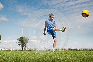 Girl kicking soccer ball