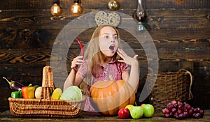 Girl kid at farm market with fall harvest. Kid farmer with harvest wooden background. Farm themed games and activities