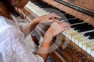 Girl kid playing piano. Selective focus