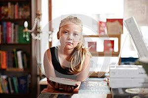 Girl kid in portrait, book and education, story for knowledge or entertainment with customer in bookshop. Library, store