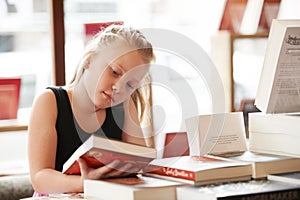 Girl kid, reading book and education, story for knowledge or entertainment with customer in bookshop. Library, store and