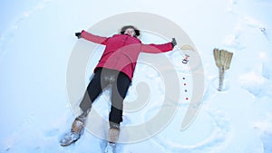 Girl kidding fell in the snow next to a snowman HD