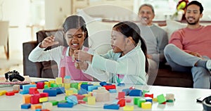 Girl kids, table and building blocks with play fight, learning and development in lounge at family home. Children