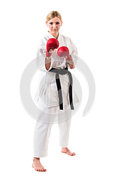 Girl in kimono for karate and boxing gloves