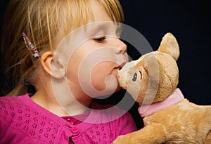 Girl kiss toy bear