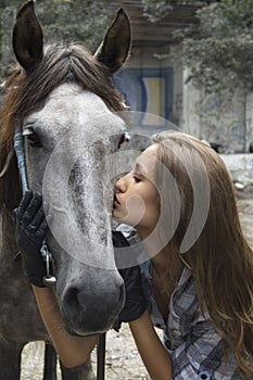 A girl kisses her horse