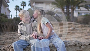 Girl kissing blond boy on cheek