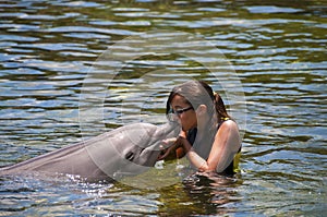 Girl kissing dolphin