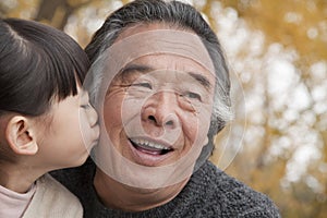 A girl kissing her grandfather