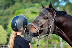 Girl kissing her horse