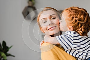Girl kissing her mother in cheek