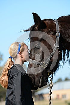 Girl kissing her pony