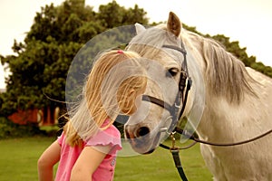 Girl kissing pony