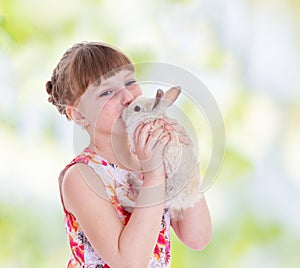 Girl kissing a rabbit