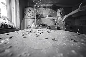 Girl on kitchen throws flower