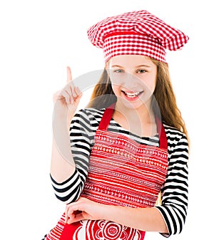 Girl in kitchen upron pointing up