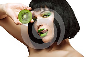 Girl with kiwi. Bright makeup