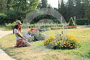 Girl kneeing in front of flowers photo