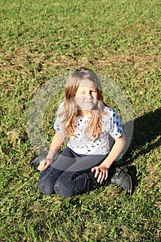 Girl kneeing on grass photo