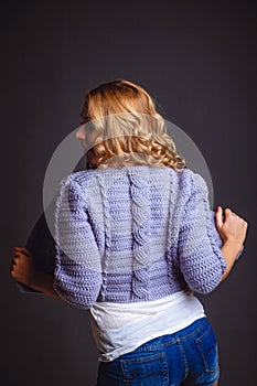 Girl in a knitted violet cardigan