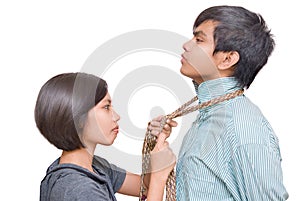 Girl knotting necktie of boy