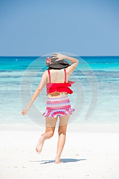 The girl on koh ta chai beach running down into the sea