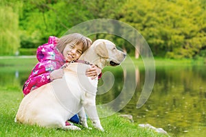 Girl with labrador retriever dog