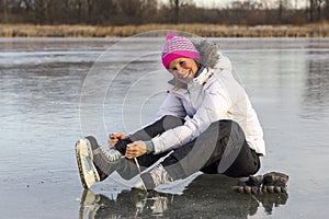 The girl in lace your skates on the ice.