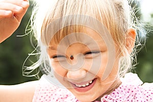 Girl with ladybird on her nose