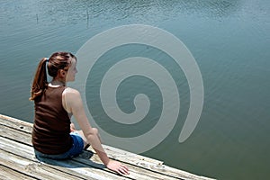 Girl at lake on dock