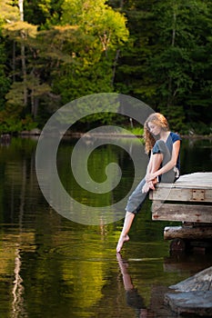 Girl on a lakeside dock