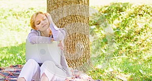 Girl laptop dreaming in park sit on grass. Dream about successful project. Woman dreamy with laptop work outdoors