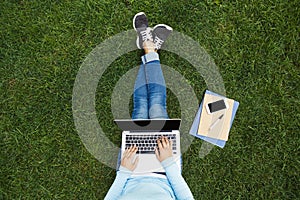 Girl with laptop on the grass