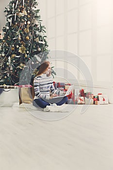 Young woman online on laptop at christmas interior