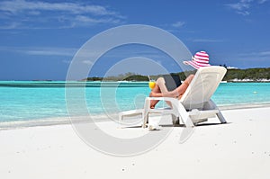 Girl with a laptop on the tropical beach