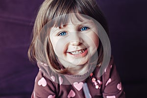 Girl with large blue eyes looking in camera