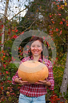 Girl with large pumpkin