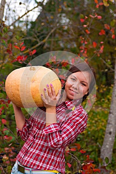 Girl with large pumpkin