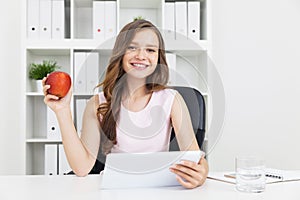 Girl with large tablet and apple