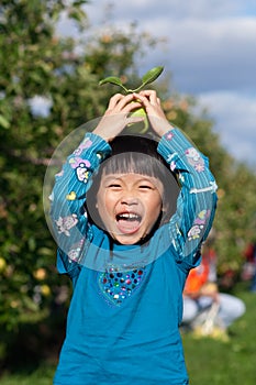 Girl Laughing and Balancing an Apple