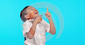 Girl laughing, child and pointing at bullying, joke or funny comic on studio, blue background or mockup. Female student