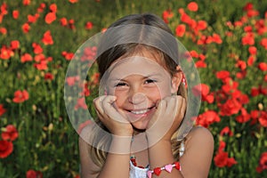 Girl laughing in a poppy field