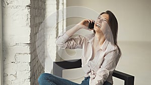 Girl Laughing while Talking on Phone