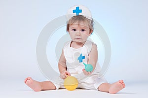 Girl laughs playing nurse with enema in hands