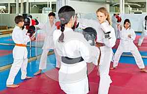 Girl launching blows on focus punch mitts