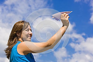 Girl launching a paper plane photo