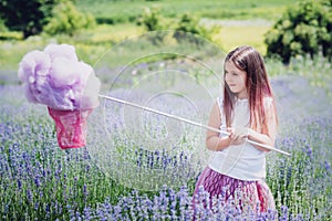 A girl in a lavender field is catching a cloud