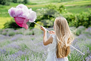 A girl in a lavender field is catching a cloud