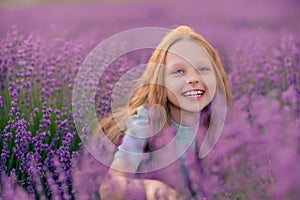 Girl lavender sunset. Girl in blue dress with flowing hair walk on the lavender field.