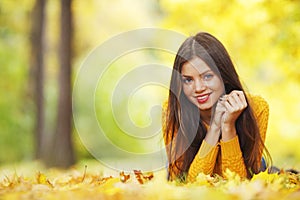 Girl laying on autumn leafs